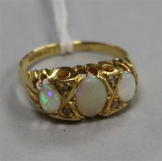 An early 20th century 18ct gold, white opal and diamond set ring, size M.